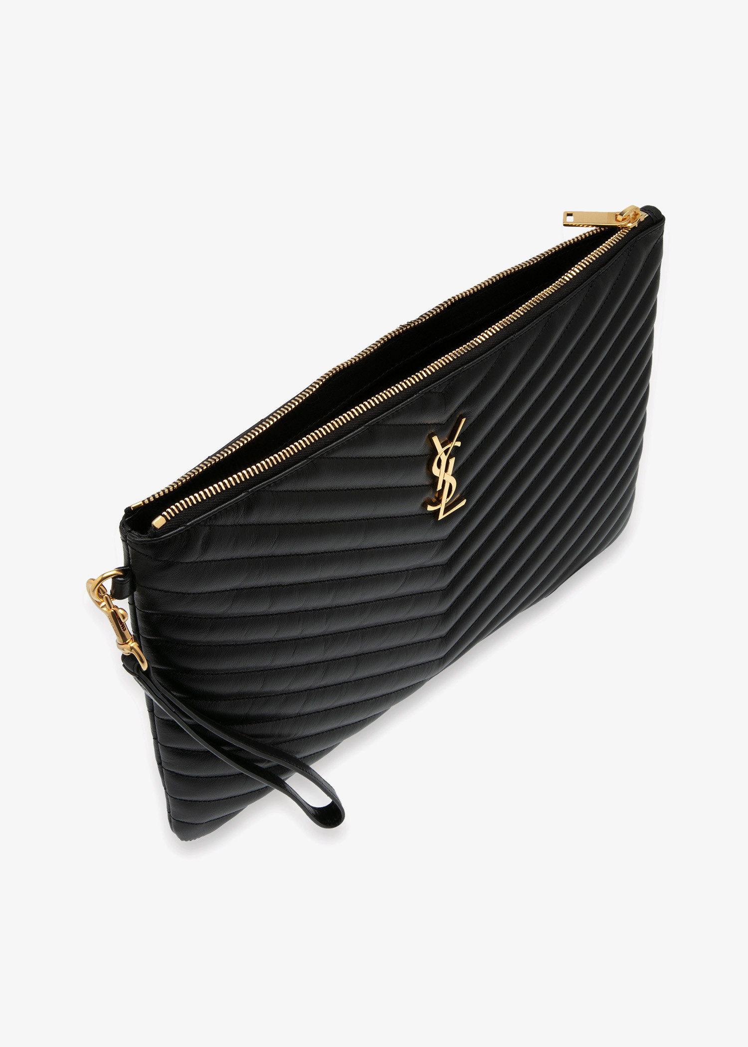 Detailed view of textured black leather and gold hardware on a Saint Laurent Cassandre pouch.