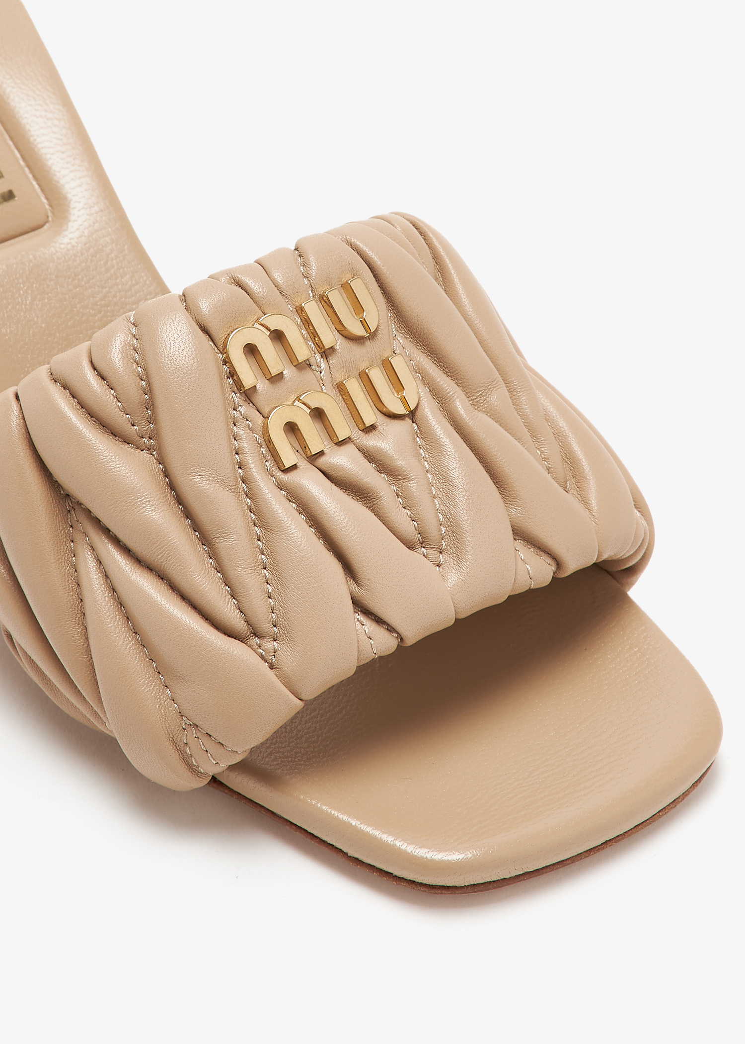 Miu Miu Matelassé nappa leather mules for Women - Beige in UAE