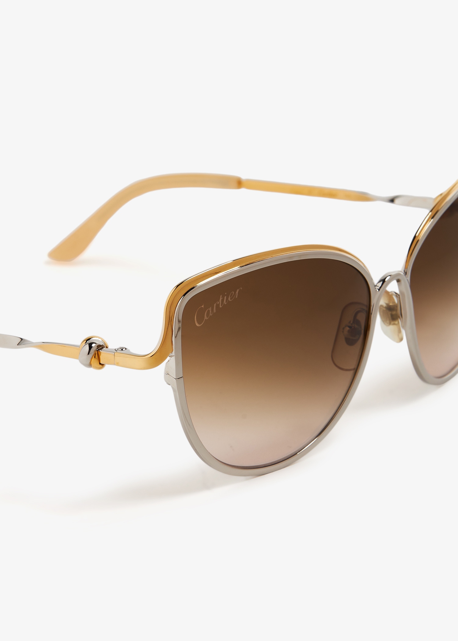 Cartier\'s Trinity sunglasses in a two-tone silver and gold tones. Three precious platings. One unmistakable statement. The  main image 3