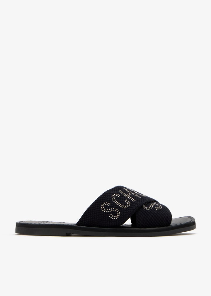 Schutz Embellished logo flat sandals for Women - Black in